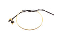 Vergoldeter Bangle-Armreif an schwarzem Macramé-Band mit rundem Onyx-Anhänger
