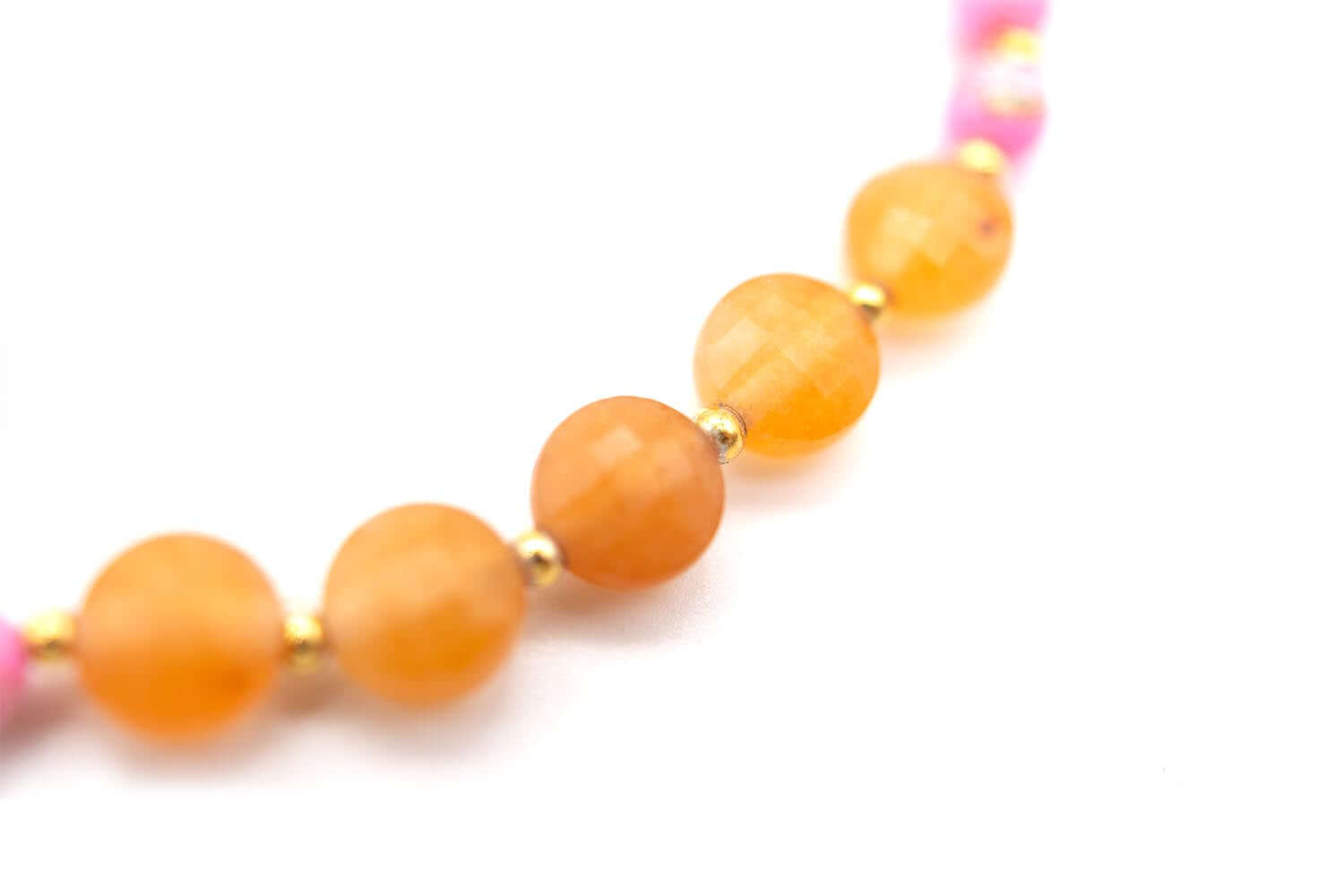Detailaufnahme der orangefarbenen Karneol-Buttons mit goldfarbenen Zwischenkugeln