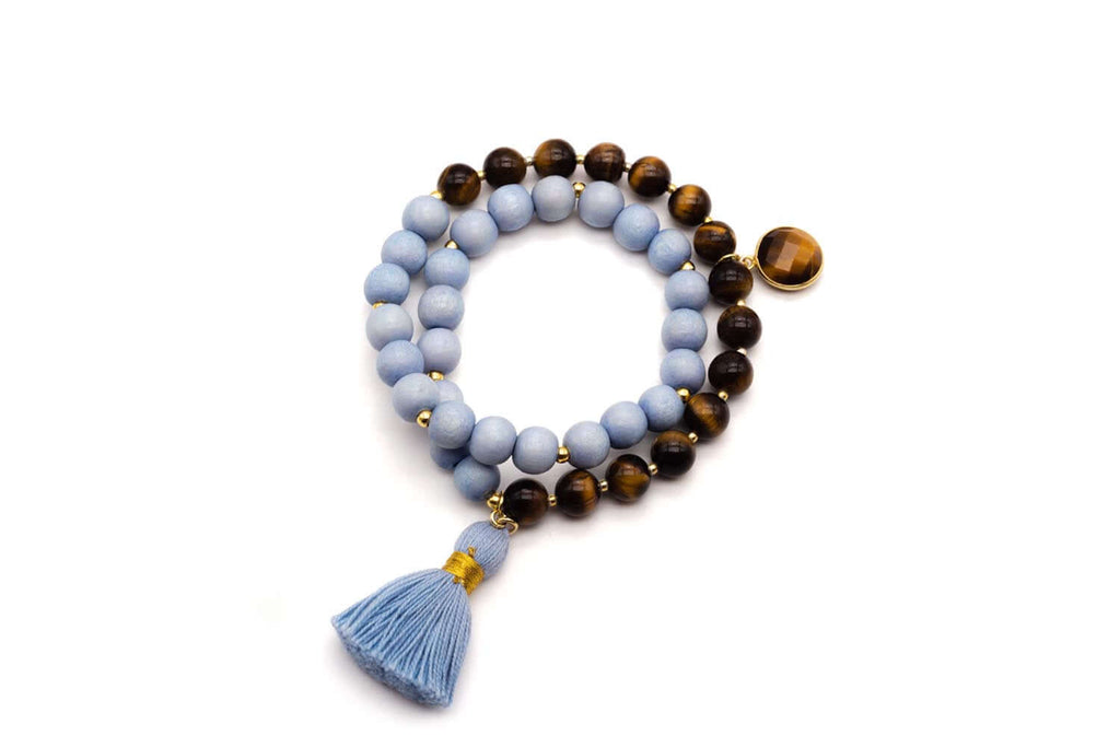 Doppelmala-Armband mit hellblauen Holzperlen, braunen Tigerauge-Perlen und blauer Quaste, freigestellt