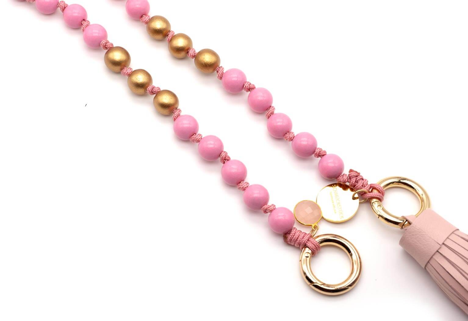 Perlenstrang aus rosa und goldfarbenen Perlen mit Verschlussring und lederner Quaste