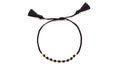 Geflochtenes schwarzes Armband mit facettierten Onyx-Perlen, vergoldeten Zwischenperlen und zwei Quasten
