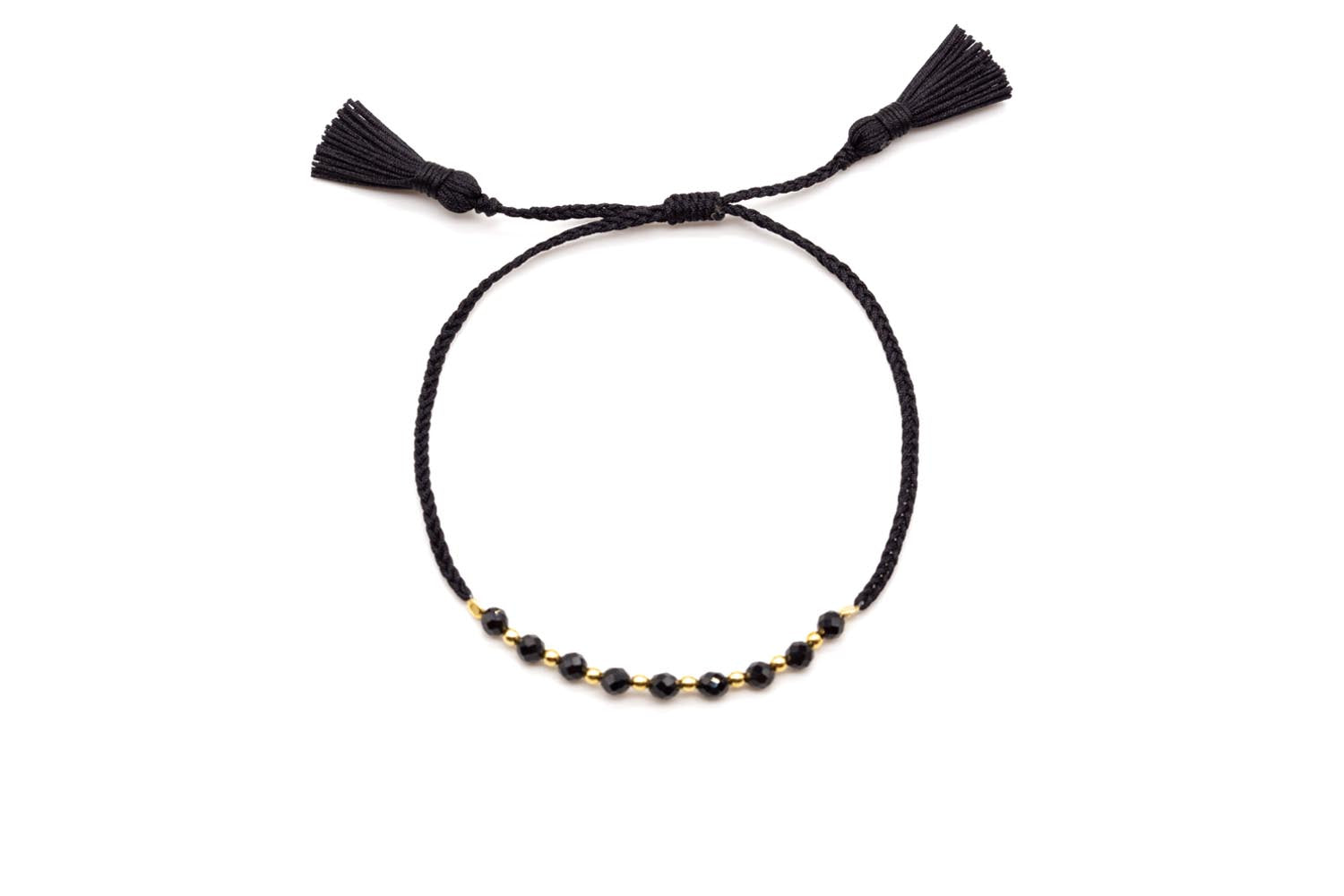 Geflochtenes schwarzes Armband mit facettierten Onyx-Perlen, vergoldeten Zwischenperlen und zwei Quasten