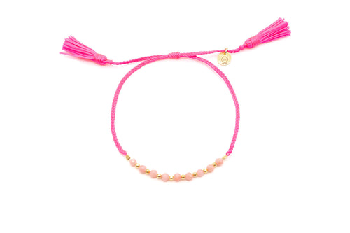 Pinkes geflochtenes Macramé-Armband mit Perlen aus Koralle, vergoldeten Kügelchen und zwei Quasten